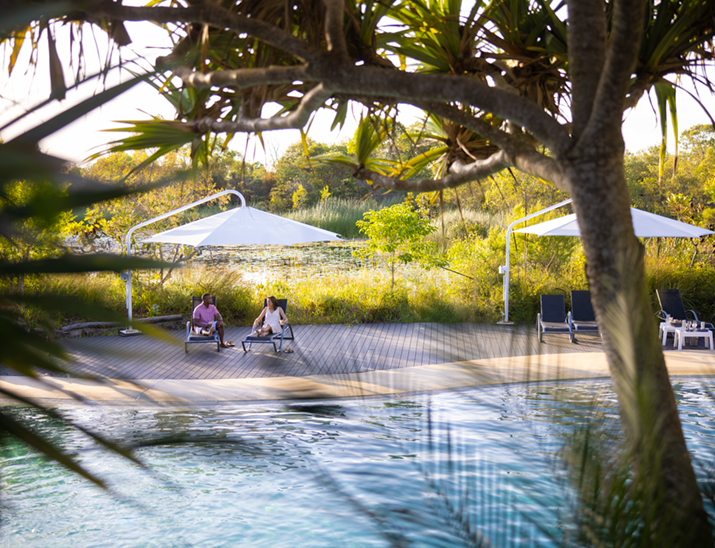 Couple sitting by the pool at Kingfisher Bay Resort