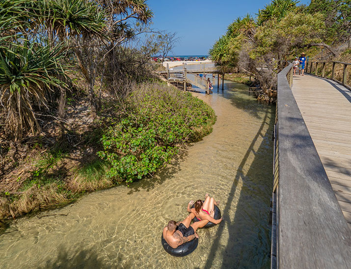 Travellers floating in rubber tubes down Eli Creek