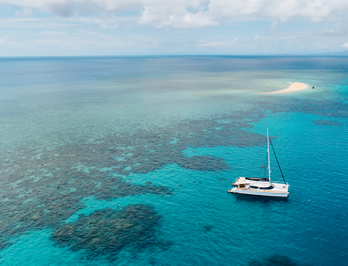 Aerial view of a sailing boat moored on the outer Great Barrier Reef